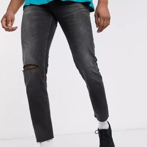 ASOS DESIGN Tall cropped slim jeans in washed black with raw hem and knee rip